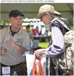 Ron Springer, left, of Buddy to Buddy, chats with USMC veteran Richard Begley during the 15th Annual Capital Area Stand Down for Homeless Veterans on Wednesday at Adado Riverfront Park in downtown Lansing. Buddy to Buddy is a volunteer program that does outreach and support for Michigan veterans. The event brings together services at a single location to provide resources for homeless veterans and those at risk of becoming homeless. More than 50 area agencies were in attendance to provide health screenings, shots, benefits enrollment, employment help, housing help and clothing. The event is put on by Volunteers of America Michigan in partnership with the U.S. Department of Veteran Affairs.