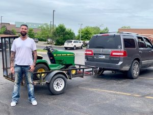 Marcus with the donated lawnmower