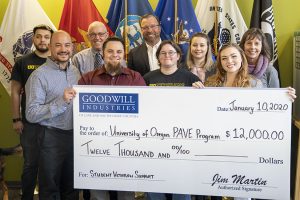 Photo of University of Oregon PAVE Program team receiving a $12,000 check from Goodwill Industries