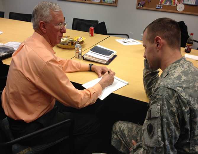 Volunteer Bob Short assisting soldier