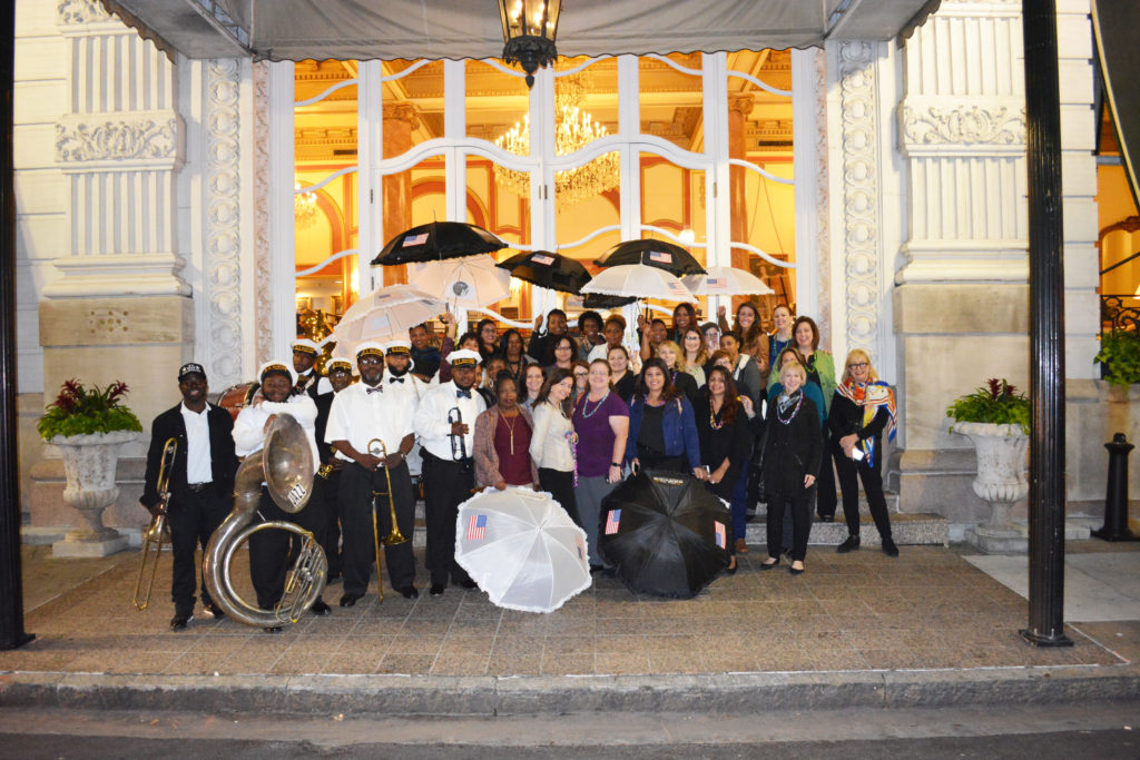After Her Service participants and M-SPAN staff posing in front of their hotel