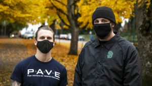 Two student veterans standing together with masks on
