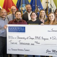 Photo of University of Oregon PAVE Program team receiving a $12,000 check from Goodwill Industries