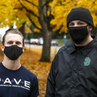 Two student veterans standing together with their masks on