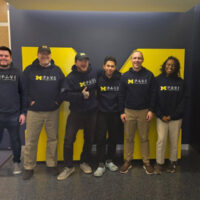 6 UM PAVE team members standing in front of a block M