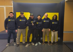 6 UM PAVE team members standing in front of a block M