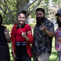 Four UNM PAVE team members standing and smiling