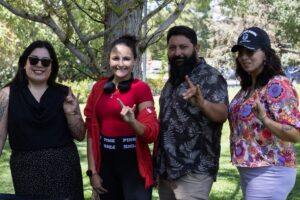 Four UNM PAVE team members standing and smiling