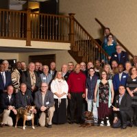 Photo of about 40 Buddy-to-Buddy Program volunteers posed as a group. Photo taken at annual Volunteer Recognition Event on April 13, 2019 in Clare, Michigan.