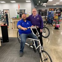 Photograph of Buddy-to-Buddy Program volunteer Fred Honerkamp with a disabled veteran he helped secure a recumbent bike for