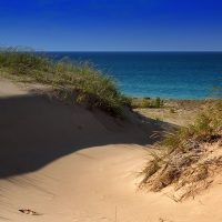 A photo of sand dunes overlooking late Michigan in late summer