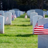 Image of a military cemetery with American flags